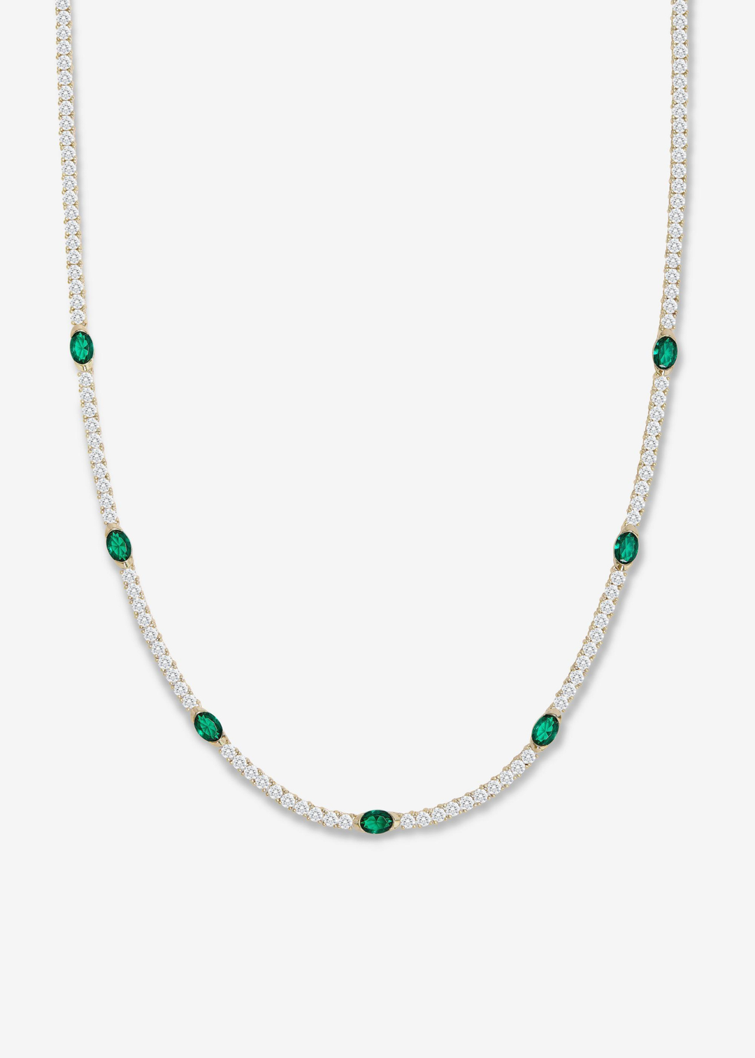 A gold framed simulated diamond and emerald tennis necklace on a white background