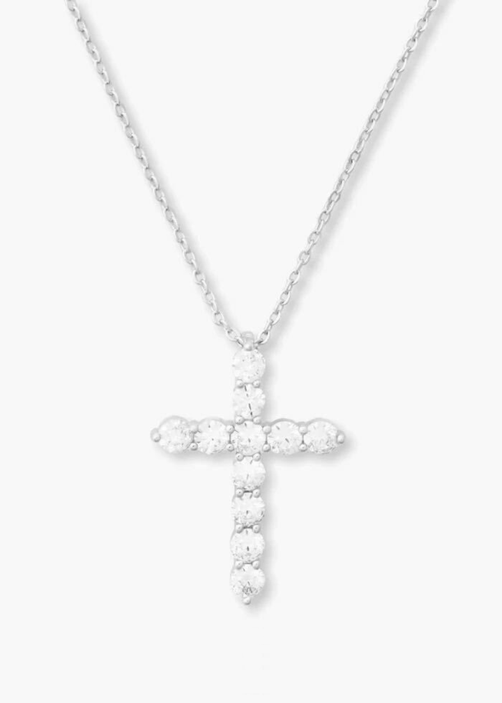 Silver cross necklace with simulated diamonds on a white background