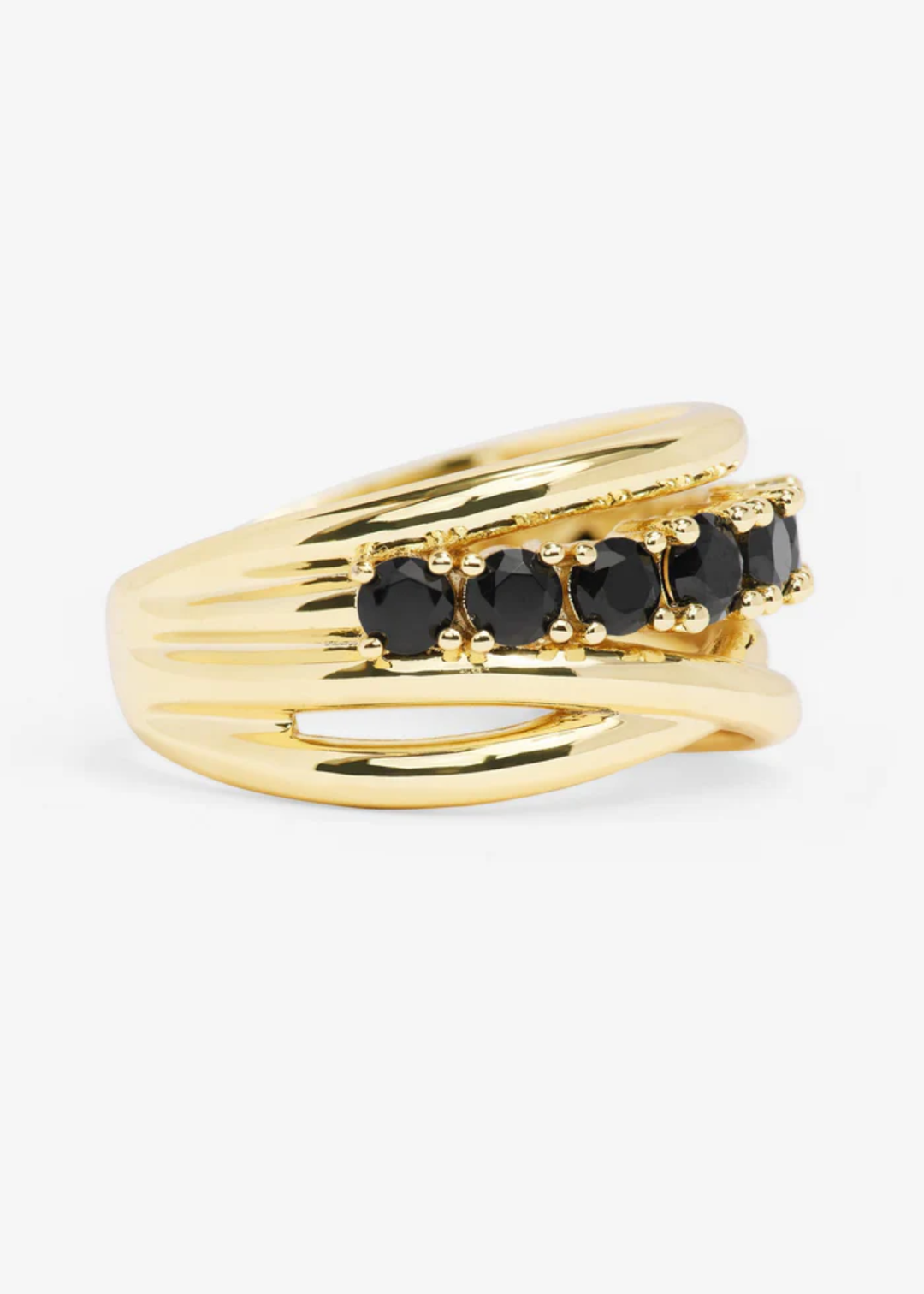 Gold stacked ring with black simulated diamonds turned to the side against a white background