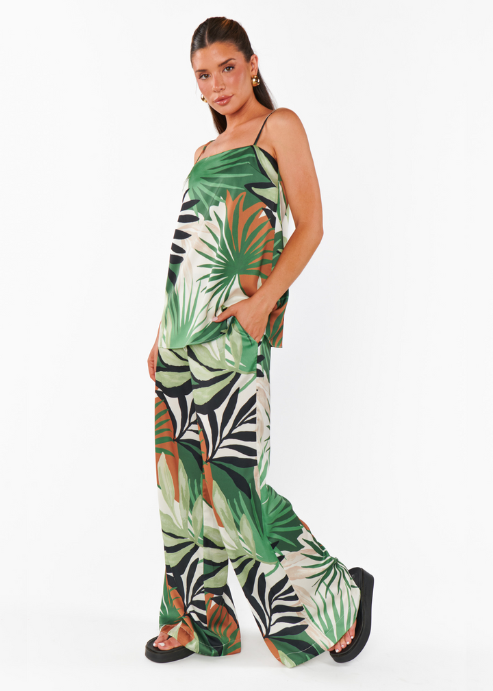 Women's wide leg pants with a green, black, white, and brown tropical print