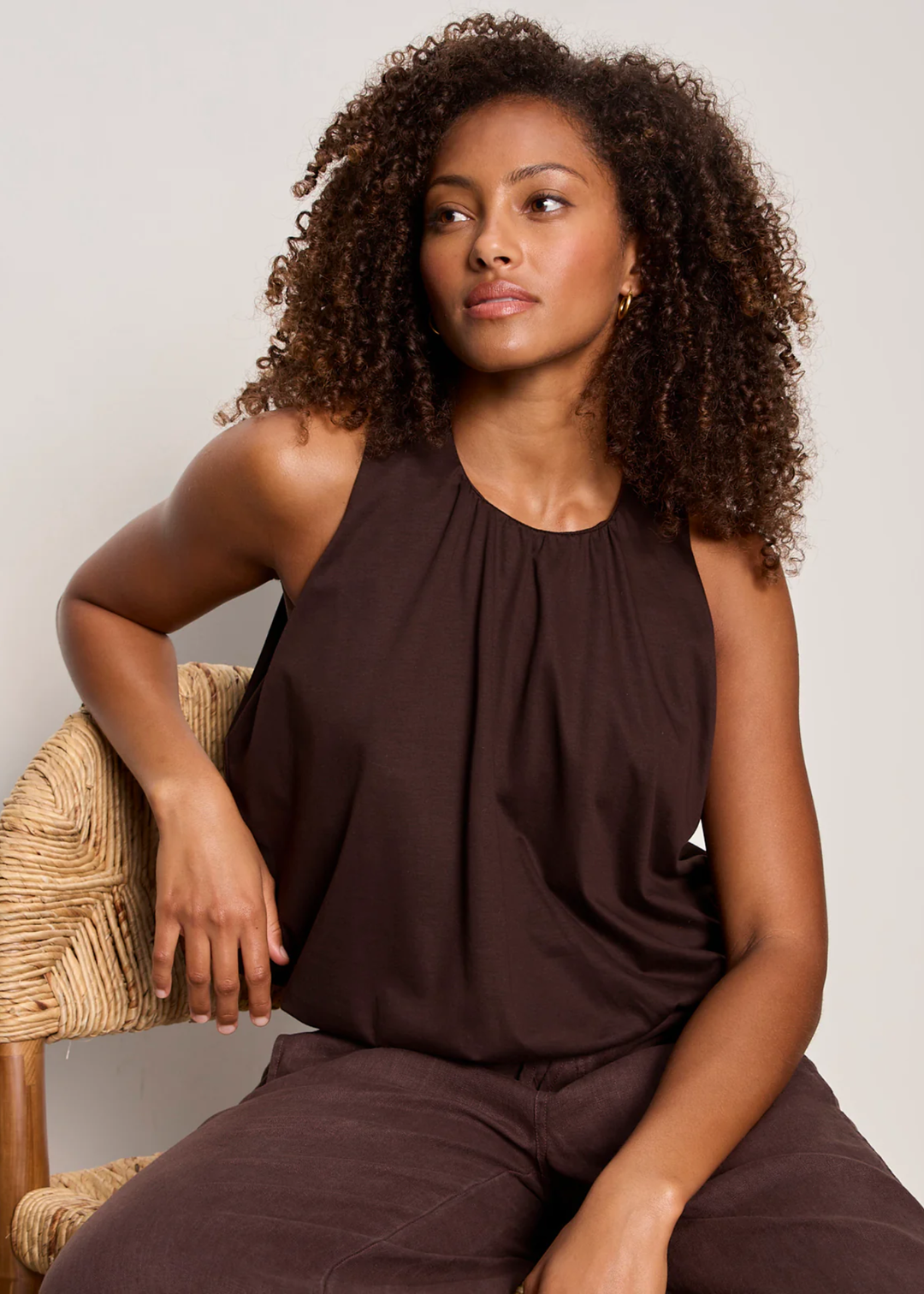 Woman wearing a brown tank top with matching pants