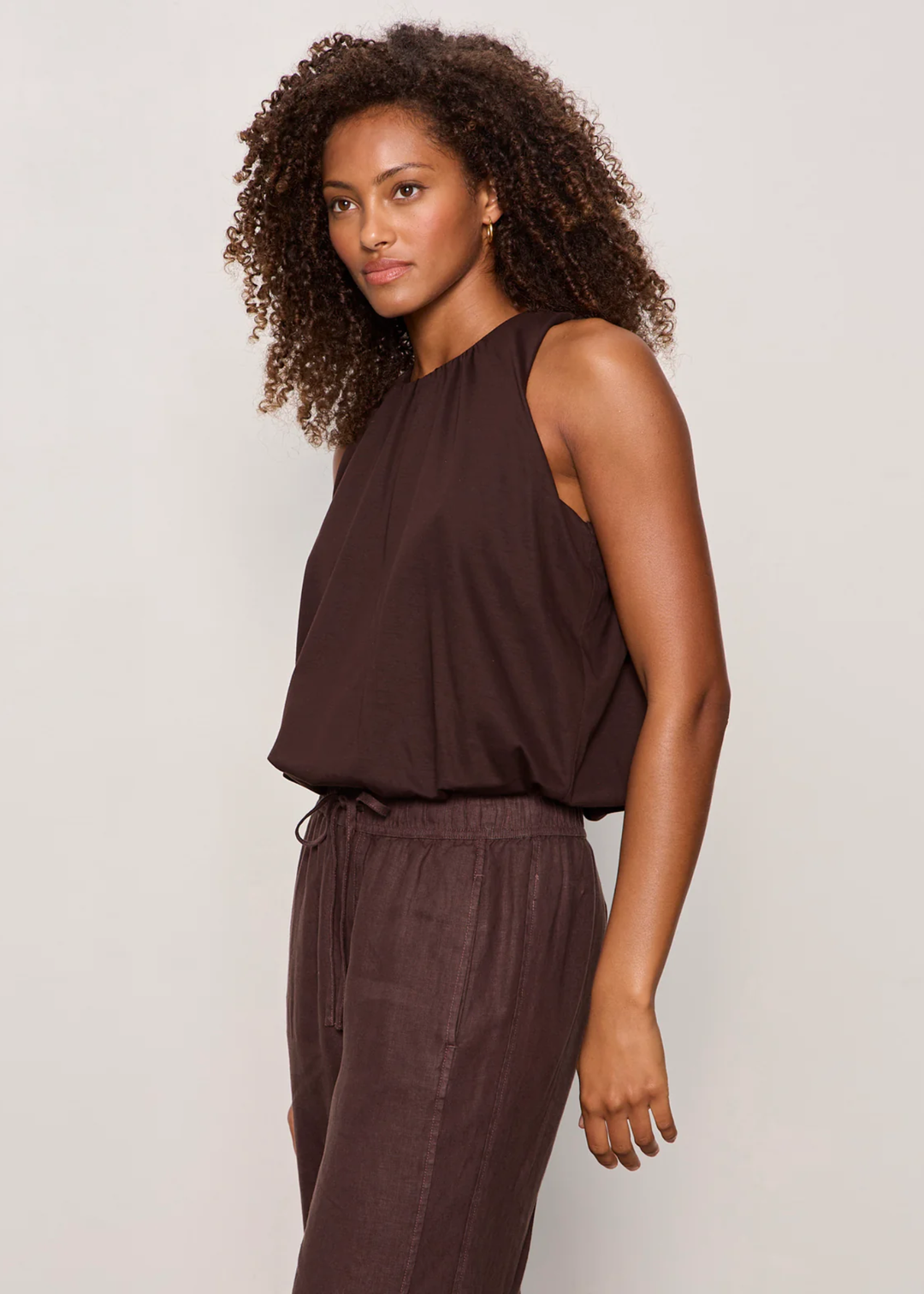 Woman wearing a brown tank top with matching pants