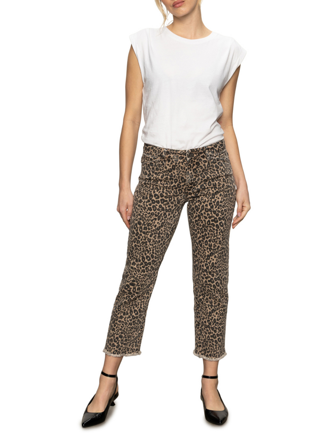 Woman wearing leopard print jeans in front of a white background