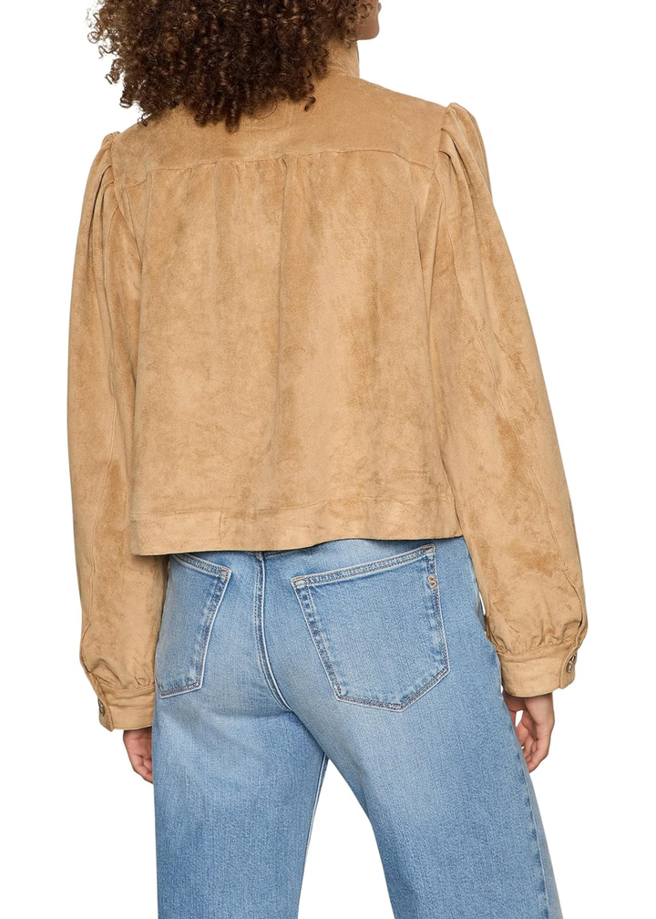 Woman turned around wearing a brown suede jacket