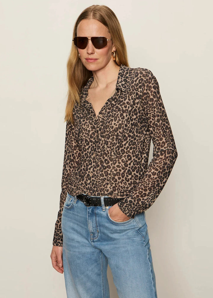 woman wearing a leopard print collared button down long sleeve top