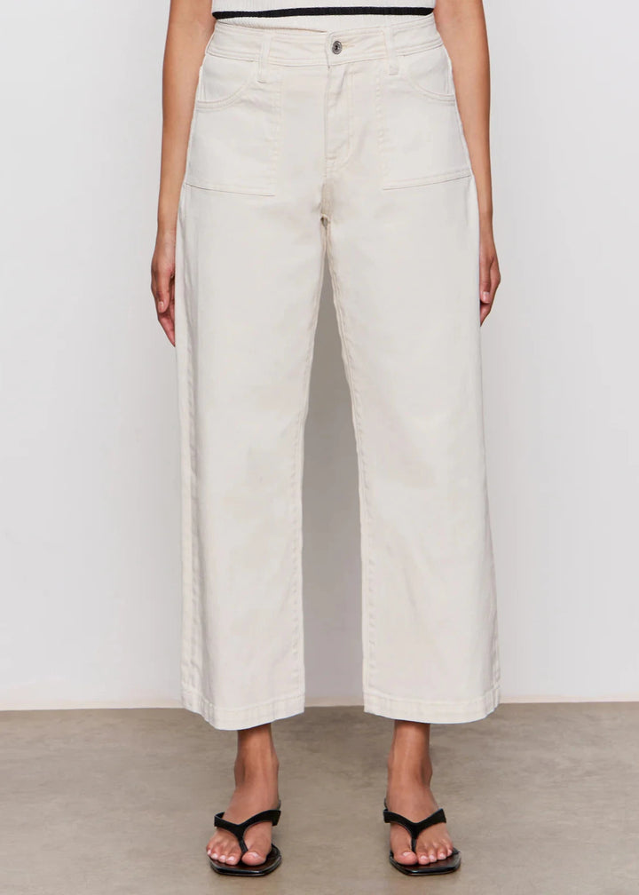 woman wearing off white wide leg denim jeans