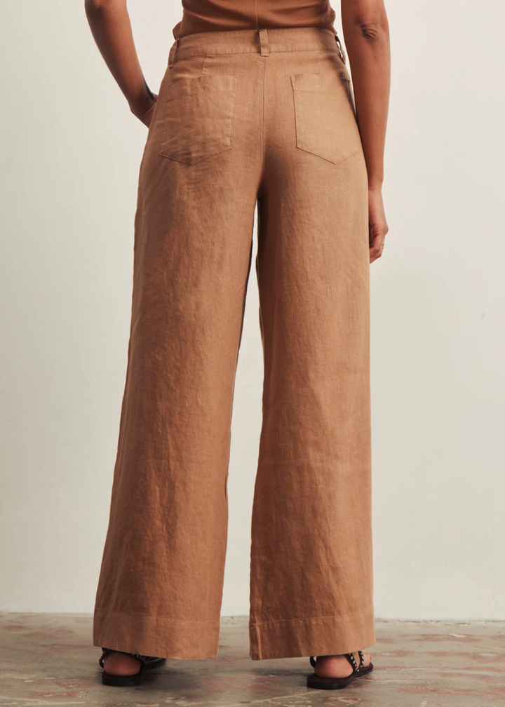 Woman turned around wearing brown wide leg pants with a brown tank top