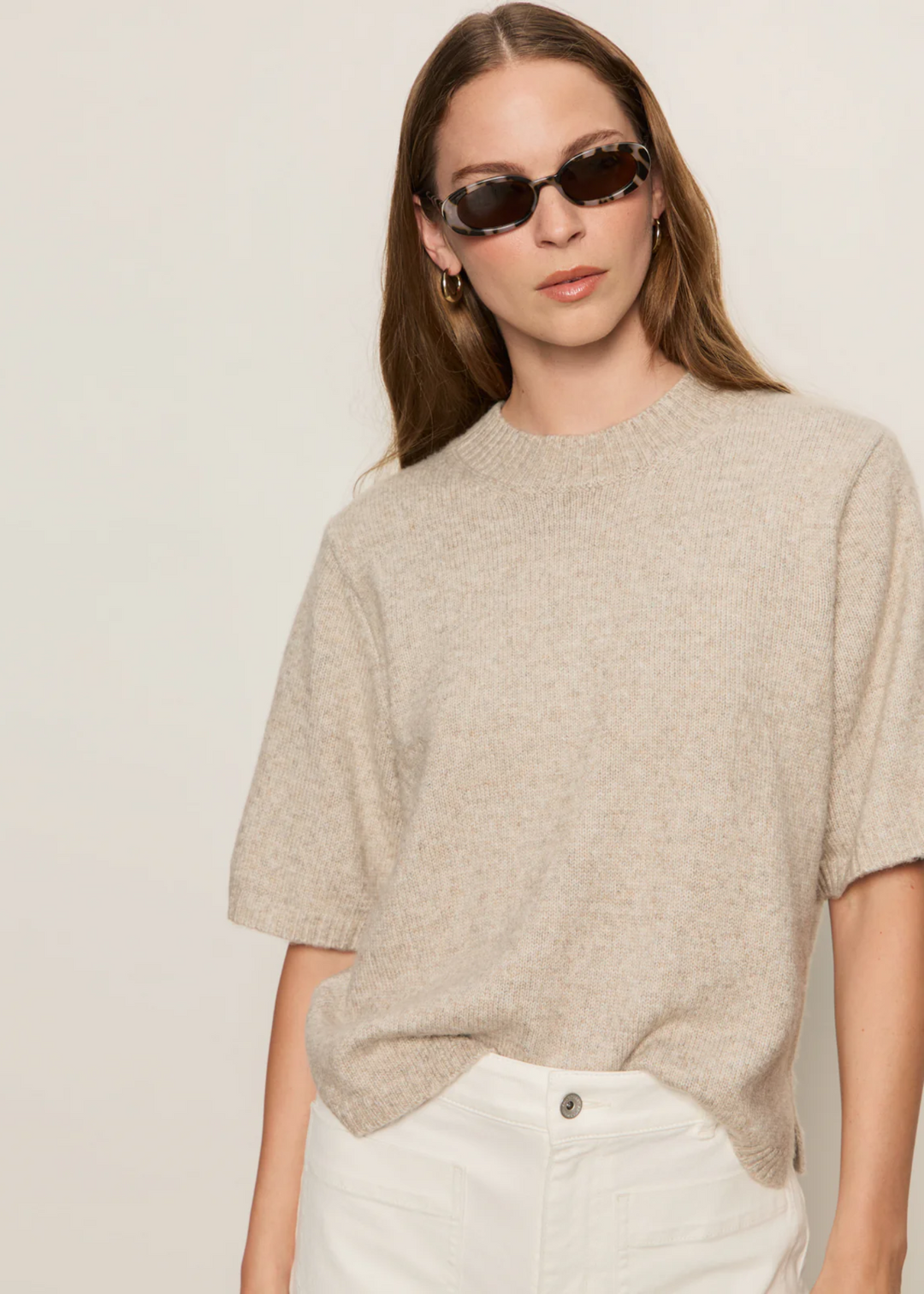 Woman wearing a tan knit sweater top