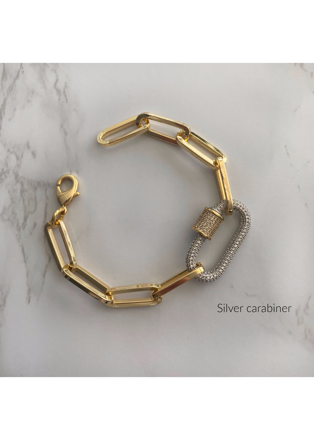 Gold paperclip chain bracelet with a silver carabiner