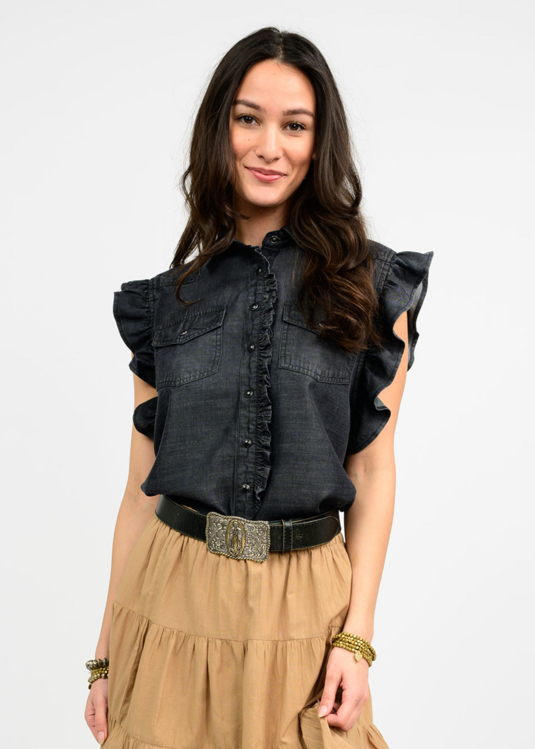 Women wearing a black button down top with ruffle sleeves