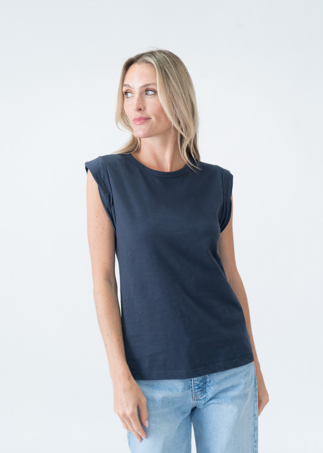 woman wearing navy blue tee with twisted short sleeves