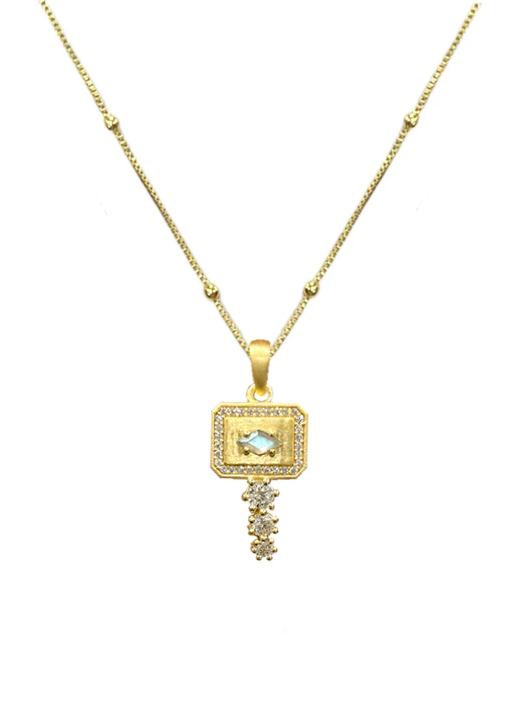 Gold pendant necklace with CZ details on a white background