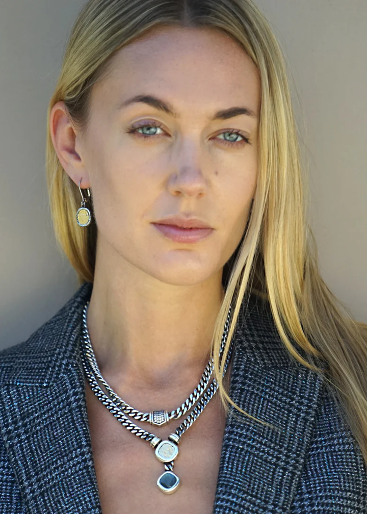 Woman wearing a vintage silver chain necklace with a pave CZ pendant