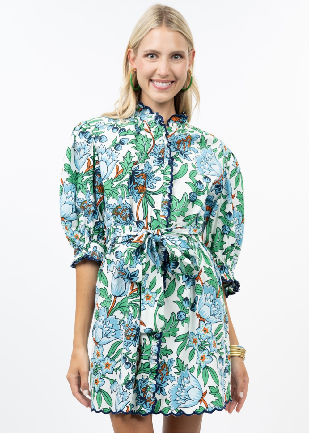 Woman wearing a blue, green, and white floral mini dress