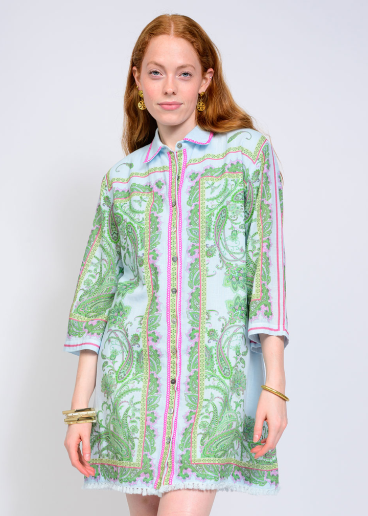 Woman wearing a blue, pink, and green button down collared mini dress