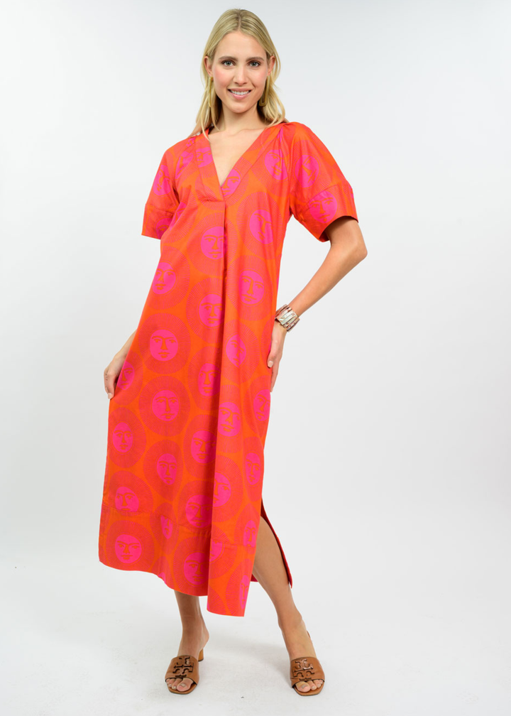 Woman wearing a hot pink and orange midi dress with sandals