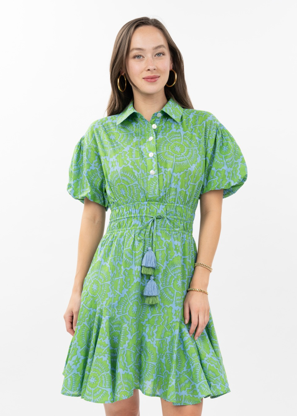 Woman wearing a green floral mini dress with puff sleeves