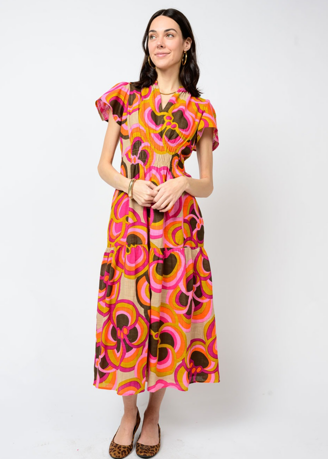 Woman wearing a pink and brown floral midi dress