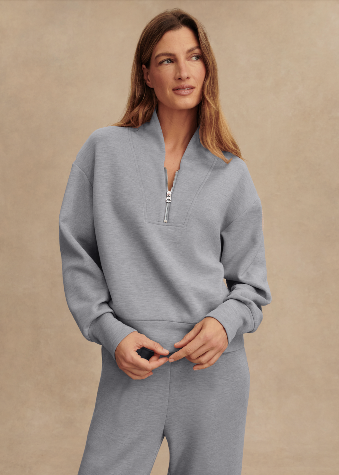 Woman wearing a blue grey quarter zip sweatshirt