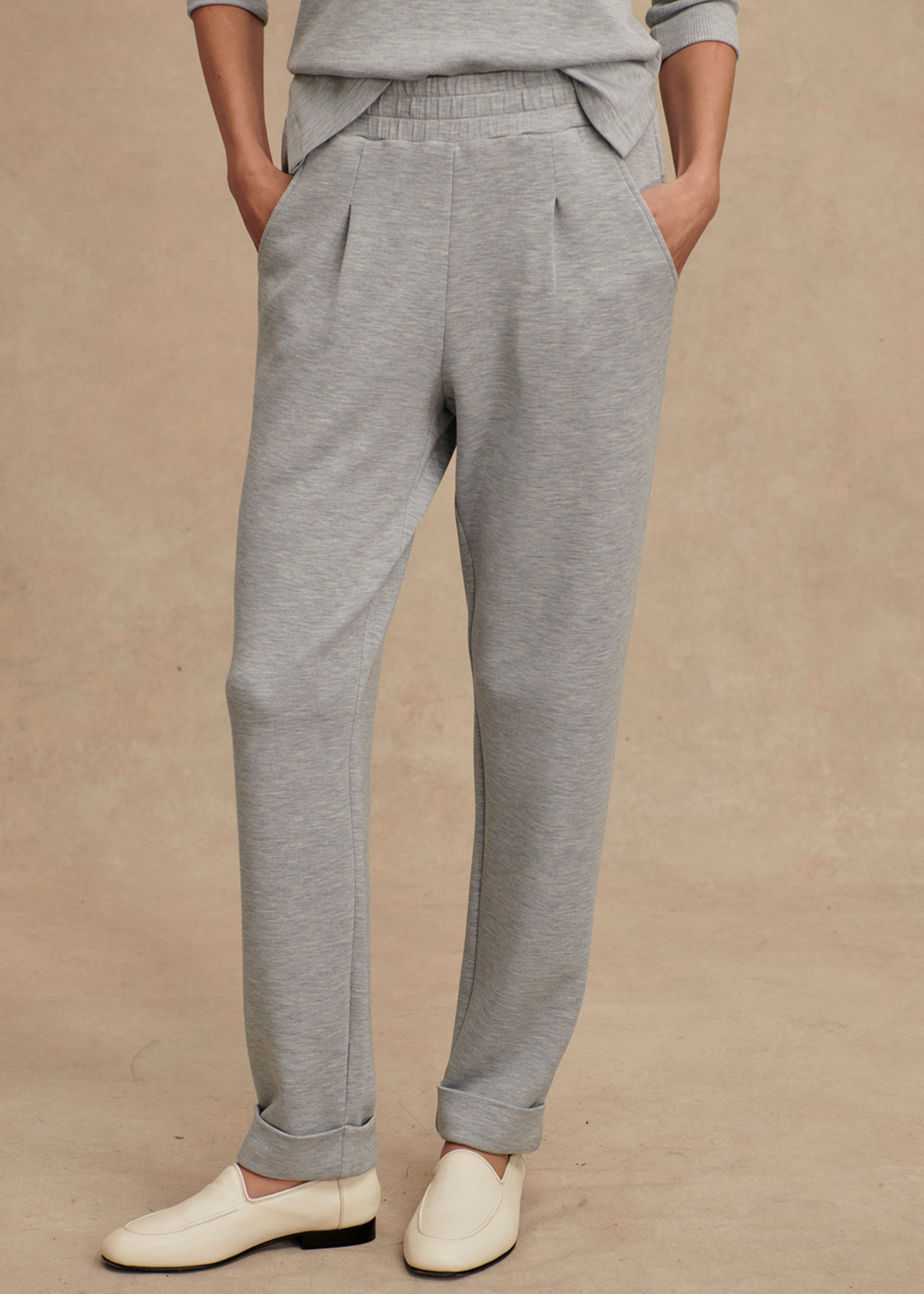 Woman wearing rolled cuff sweatpants in a grey blue color