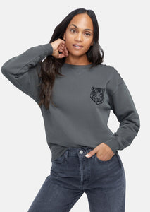 washed black sweatshirt with small tiger graphic on left chest and "wild at heart" printed in bold letters on the back