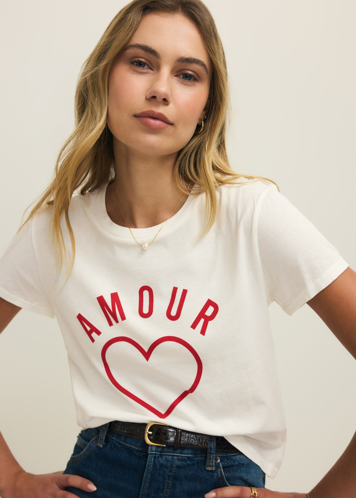 Woman wearing a white t-shirt with a red heart and "AMOUR" lettering