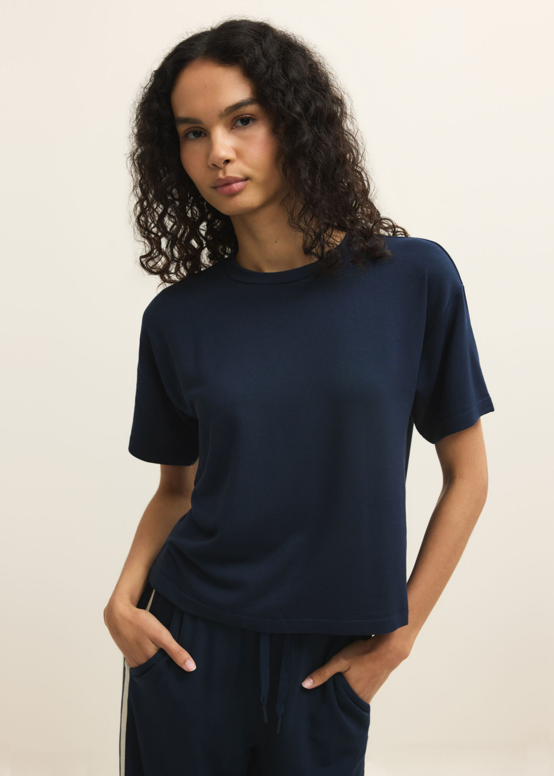 Woman wearing a navy short sleeve tee with navy pants
