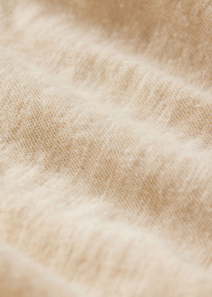 Close up of the fabric of a tan t-shirt