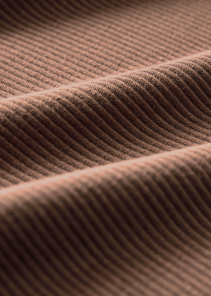 Close up of the fabric of a brown ribbed tank top