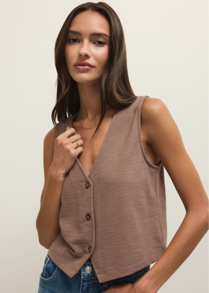 Woman wearing a brown textured button down tank with jeans