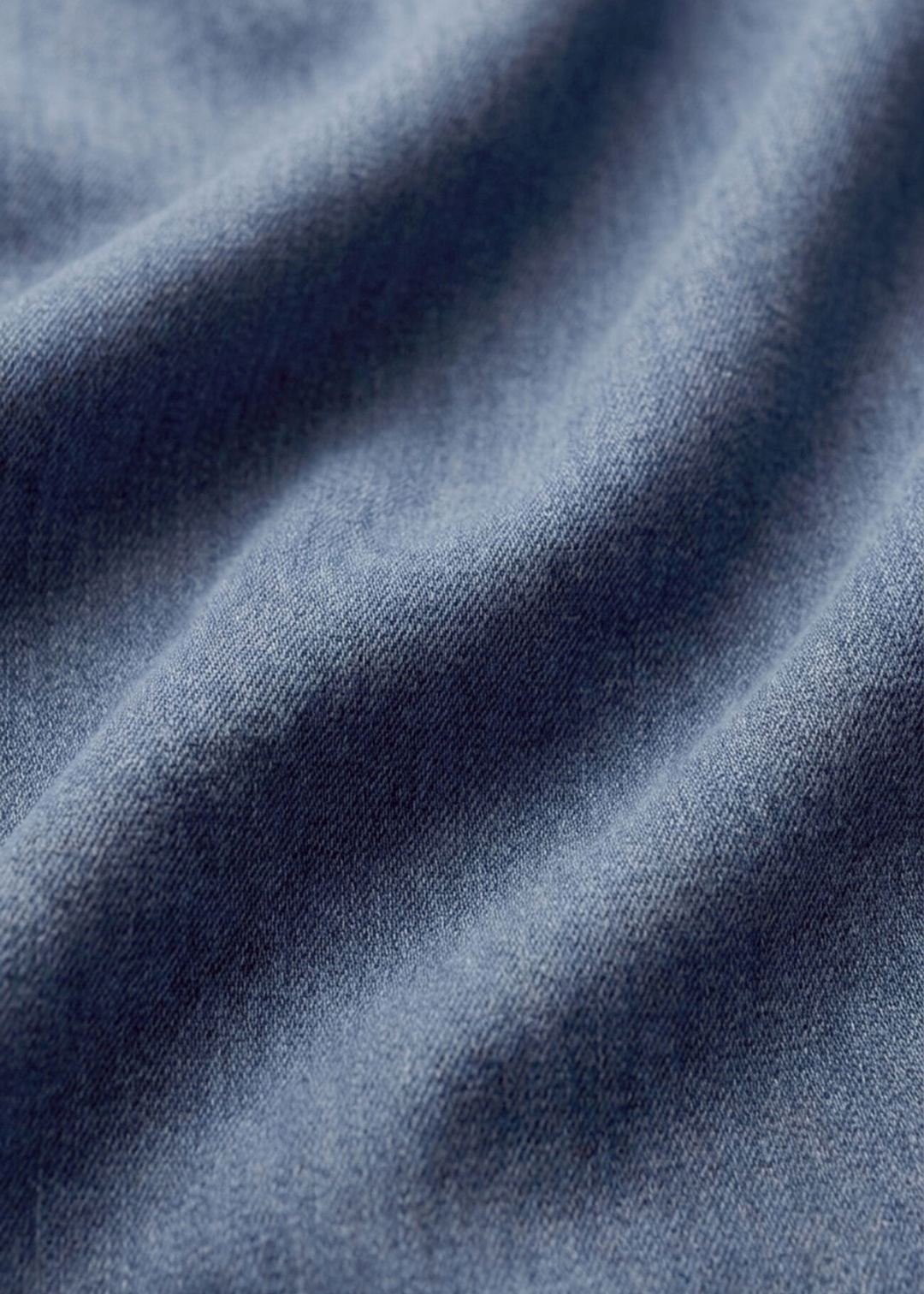 Close up of a knit denim button down