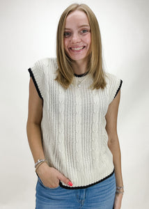 cream cable knit sweater vest with black trim 