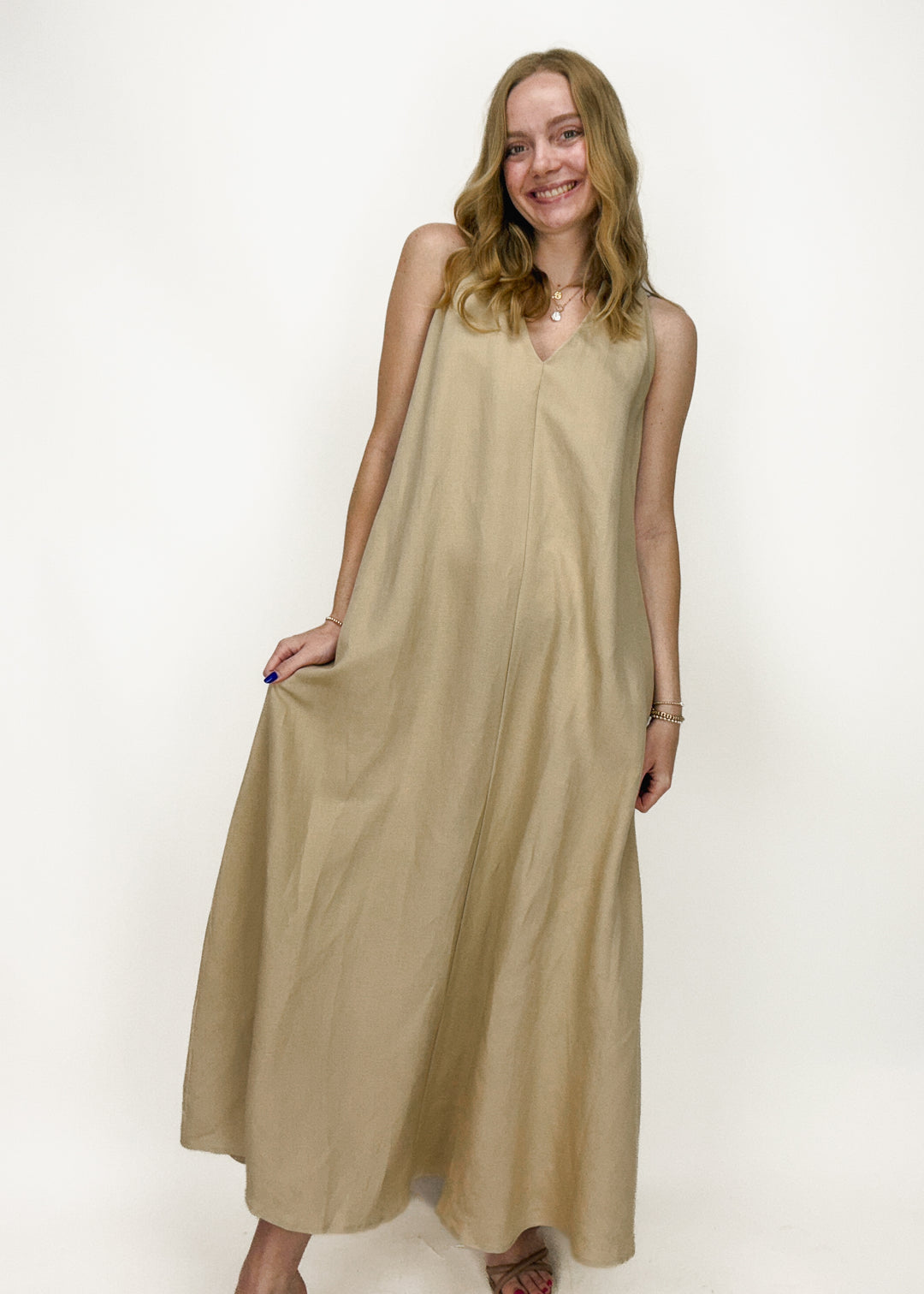 woman wearing khaki sleeveless v-neck maxi dress