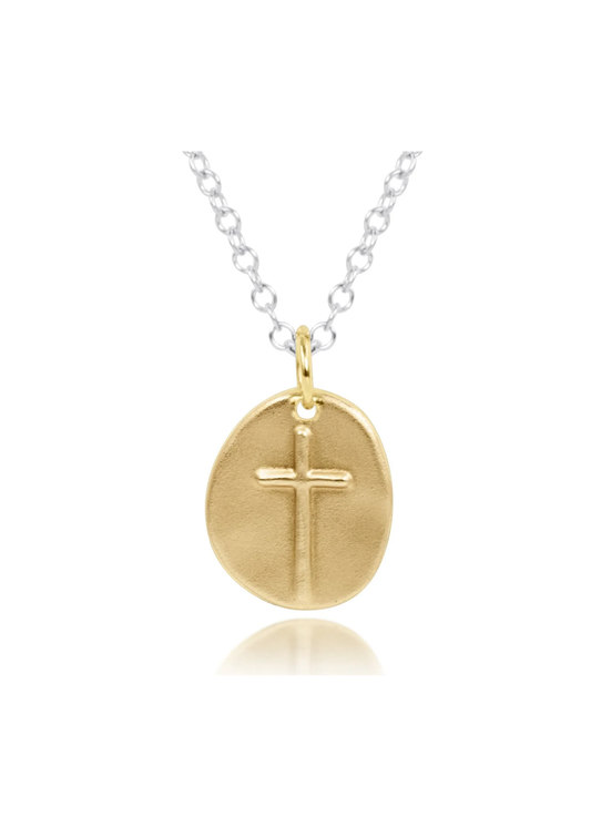 Silver chain necklace with a large gold cross charm on a white background