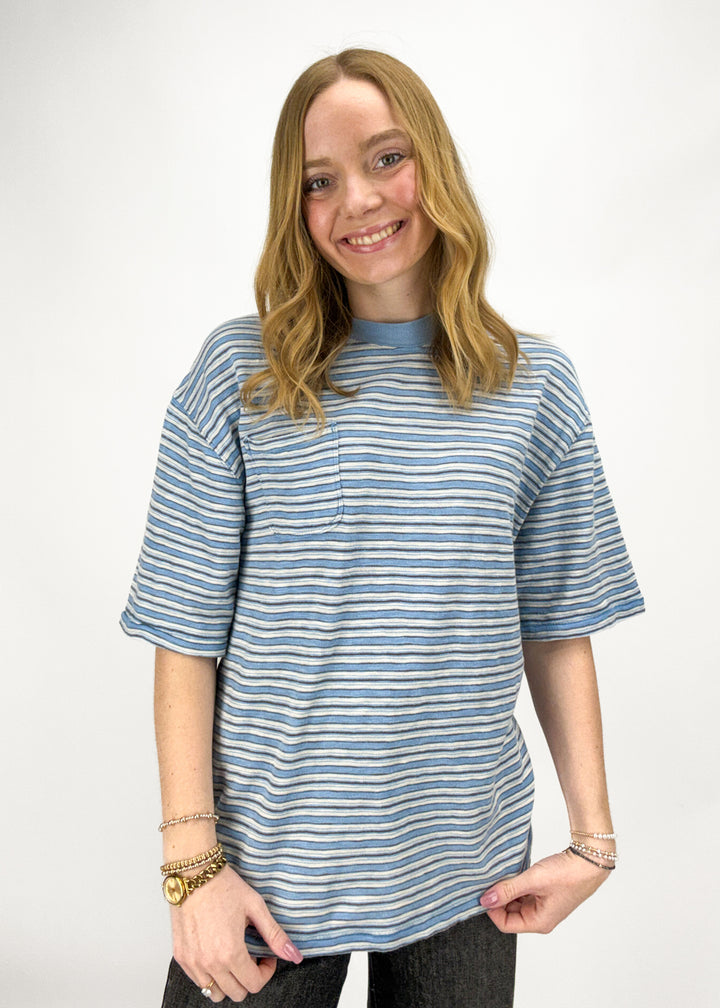 Person wearing a blue and white striped shirt on a white background