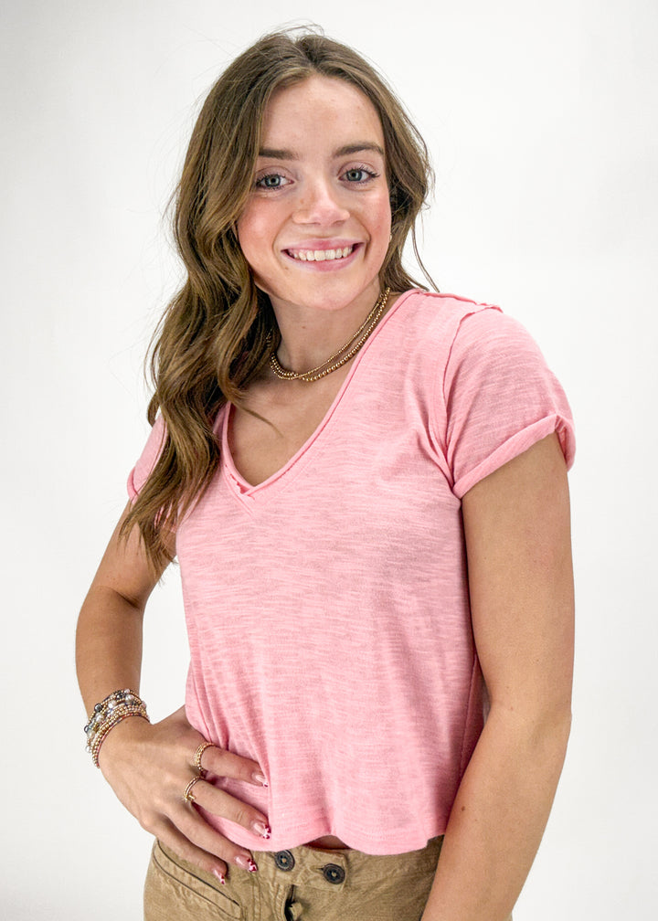 Woman wearing a pink t-shirt on a white background