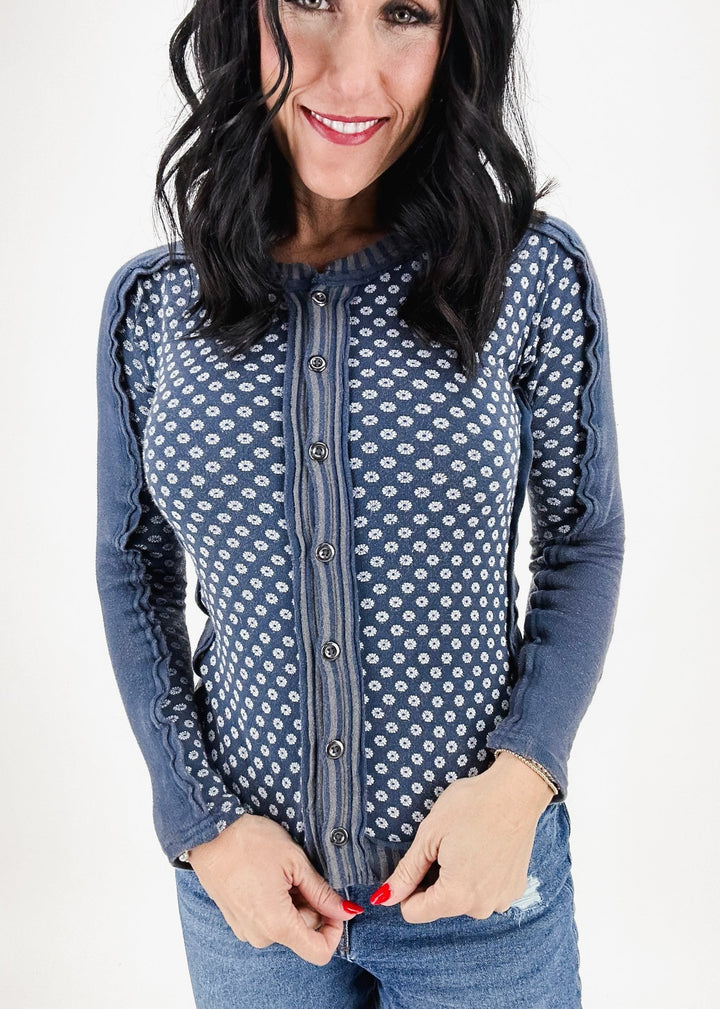 indigo blue long sleeve tee with white print on chest and buttons down the front