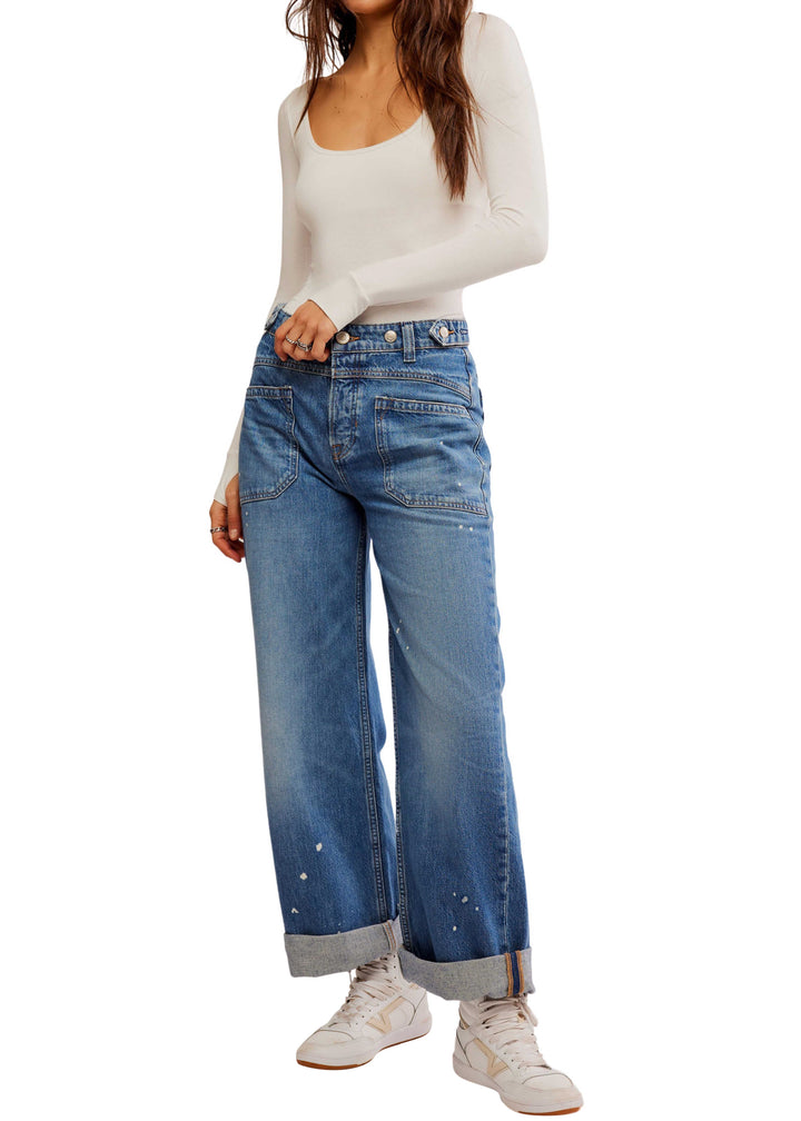 medium wash denim jeans with cuffed wide legs and adjustable waist buttons