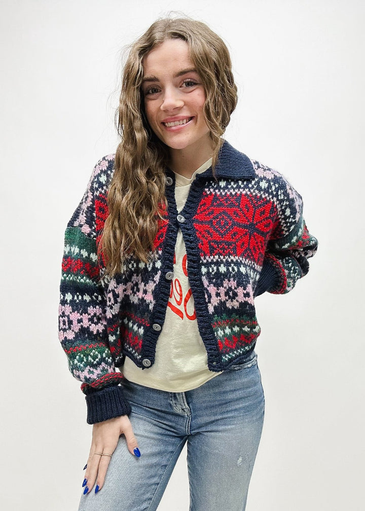 navy blue, red, pink, and green holiday print collared cardigan sweater