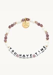 purple crystal and pearl bead bracelet with square beads that read "you have time"