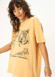 mustard yellow oversized tee with tiger graphic that says "extinct is forever"