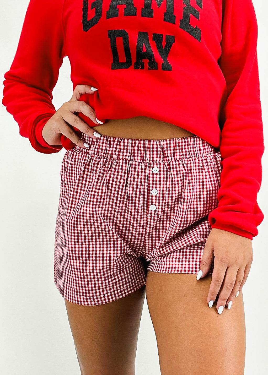 red and white choker shorts styled with red crew neck with black varsity letter "game day" printed on chest