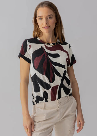 cream base short sleeve tee with black and burgundy abstract leaf print