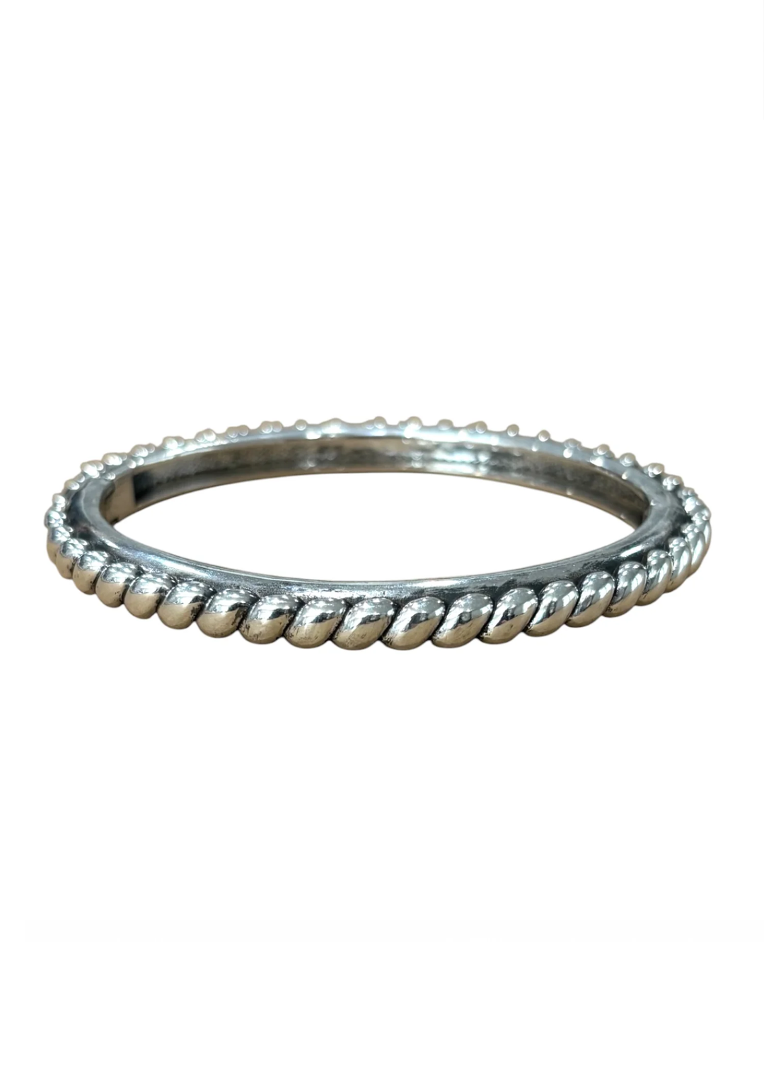 A silver-toned bangle bracelet with a textured, rope-like beaded pattern around the outer edge, shown against a plain white background.