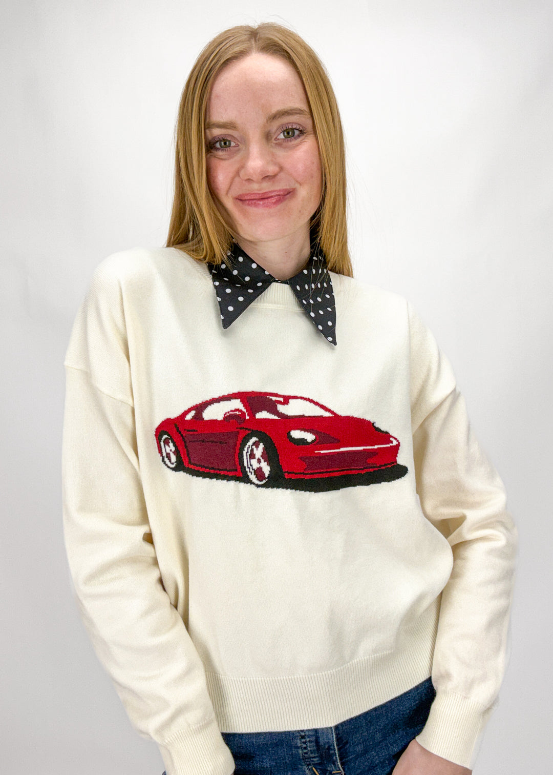 Person wearing a black and white polka dot layering dickey