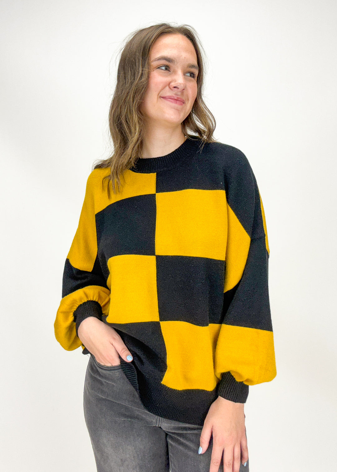 Woman wearing a black and yellow checkered sweater