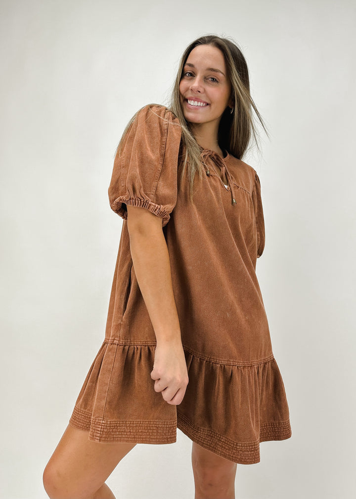 Women's brown tiered mini dress with puff sleeves and a relaxed fit, perfect for a casual and comfortable look