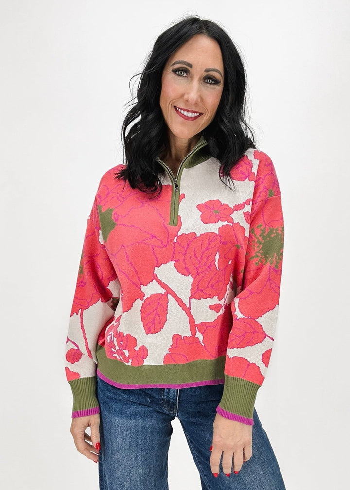 woman wearing coral and olive floral print 1/4 zip sweater syled with medium wash Kut From the Kloth jeans