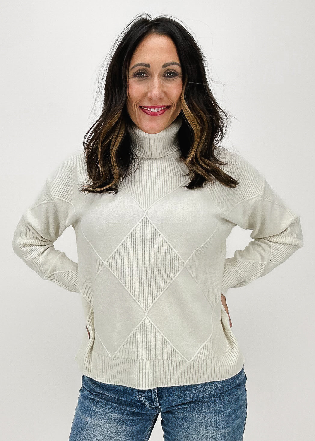 ivory sweater with textured diamonds and ribbed turtleneck