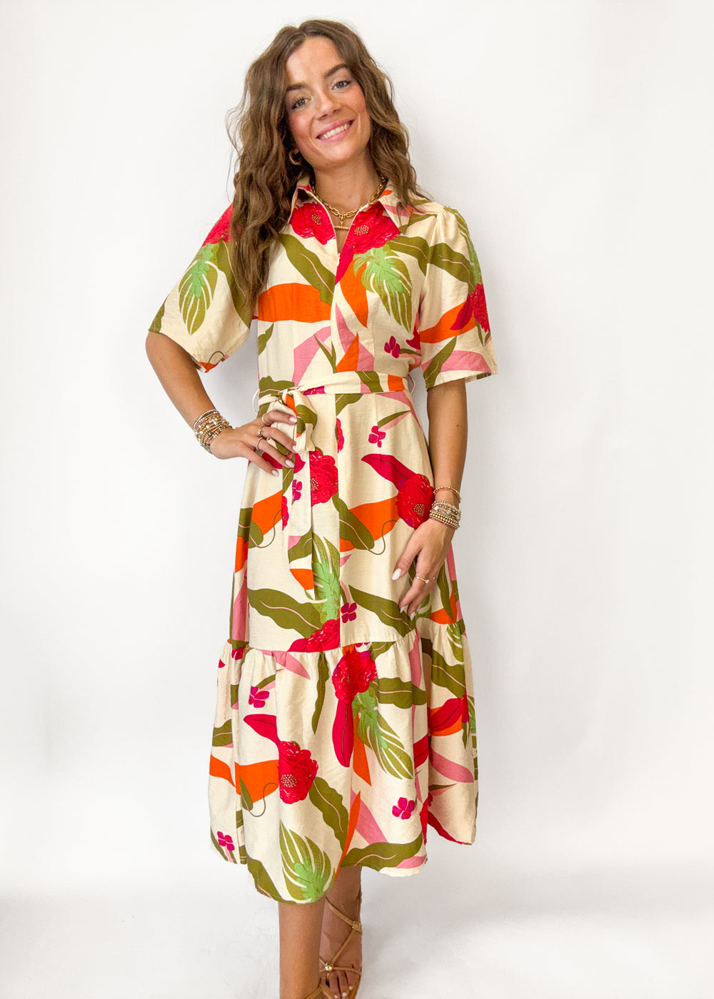 Woman wearing a colorful floral dress on a white background